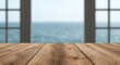© AkuAku - Natural light and blurred ocean visible through window behind wooden plank table copy space
