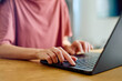 © we.bond.creations - Woman hands typing on a laptop keyboard, representing concepts of remote work, online learning, and technology use