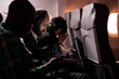 © DC Studio - Multiethnic group of people flying in economy class together to arrive at destination, man using laptop computer during international flight. Tourists travelling abroad by airplane.