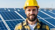 © MopoWe - Bearded male engineer in yellow hard hat smiling in front of blue solar panels at a renewable energy farm during a bright sunny day outdoors
