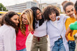 © Xavier Lorenzo - Happy diverse women walking and laughing outdoors. Friends sharing joy, trust and connection in a lively urban setting. Friendship and diversity concept.