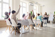 © Studio Romantic - Students and teenagers raise hands during classroom lesson. The teacher guides education in a school, boosting participation and questions with a flipchart. Active classroom learning concept.
