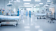© Alexander - Blurred view of a bright hospital ward with patient beds, medical equipment, and healthcare workers moving through a clean sterile environment, soft focus clinical background empha