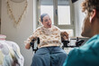 © PintoArt - Woman with disability smiling during happy home conversation