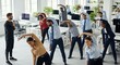 © Musarrof - Diverse group of office employees doing stretching exercises with a fitness trainer in a modern workspace for workplace wellness.