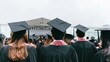 © Breezze - Graduates in black caps and gowns attending university commencement ceremony, viewing stage from behind in auditorium setting, academic banner and professional event context