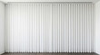 © HADI INCREDIBLE - A large window covered with white vertical blinds in a modern room with a dark wood floor and white walls