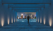 © ImageFlow - Man on terrace facing night skyscrapers in modern minimalistic style on urban skyline background showing concept of business success and city ambition