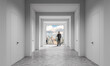 © ImageFlow - A business person in a minimalist hallway facing a bright city skyline in USA on a clean interior background, concept of success and opportunity