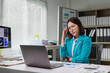 © Phimwilai - Stressed businesswoman suffering headache working in office