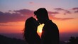 © Babb - Silhouetted couple kisses as sun sets behind them