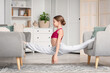 © Pixel-Shot - Cute girl doing gymnastics at home