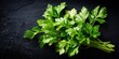 © Лаra Wladdim - Fresh green parsley. Against a black stone background. Top view.