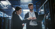 © Gorodenkoff - Two specialists use a laptop to review server rack electronics, check device connections, and monitor network cables in data center, business infrastructure, it service, saas software operation