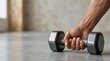 © Helen - A man's hand grips the heavy dumbbell tightly