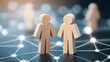 © Bonsales - Two wooden human figurines communicating, creating global network connections and demonstrating social relationships