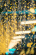 © goami - festive blurred lights with green leaves, golden holiday glow defocused through foliage background, christmas or new year eve garland bokeh
