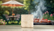 © magdal3na - Marble podium on table with garden barbecue background – summer lifestyle product mockup. Garden setting with barbecue elements with warm and relaxed outdoor atmosphere. Spring or summer vibes.