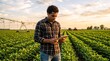 © Vasiliy - Farmer using digital tablet in soybean field at sunset. Young man checking crops with technology. Modern agriculture concept