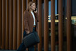 © Jelena - Businesswoman walking and talking on mobile phone