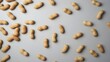 © Intellectual - Top view of unshelled peanuts scattered on a clean gray background, creating a minimal food composition. Natural texture and earthy tones highlight a healthy snack and organic ingredient concept.
