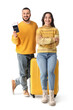 © Pixel-Shot - Young couple with passport and suitcase on white background. Travel concept