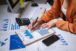 © apichat - Businesswoman analyzing data graphs accounting financial reports