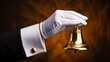 © Ansar - Hand with white glove ringing service bell representing hospitality attention and assistance