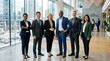 © Dara - A diverse group of business professionals standing in a modern office lobby.