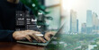 © wasan - Business professional working on laptop with virtual data analytics dashboard, AI interface, and financial charts over modern city skyline, representing digital transformation, smart technology.
