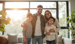 © DruZhi Art - Young Family in New Home – Mother Father Daughter and Son Embracing in Sunlit Living Room for Family Housing Concepts and Real Estate Marketing