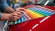 © Naufal - Customer selecting car color palette at a modern dealership showroom, comparing finishes and options before purchase decision.