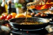 © koosy - Hand pouring cooking oil into a frying pan, surrounded by fresh vegetables. Ideal for culinary, cooking, and healthy eating contexts. Perfect for recipe blogs, food marketing,kitchen lifestyle content