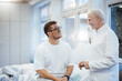 © Westend61 - Doctor talking with patient at clinic hospital indoors