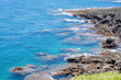 © kuenlin - LANYU, TAIWAN - JUN 25, 2025: Close-up of volcanic rocks and crystal clear turquoise ocean water along the coastline.