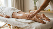 © Frendev - Therapist provides manual lymphatic drainage on the lower leg on a massage table for swelling reduction, wellness, and recovery