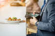 © PhamHong - Businessman Checking Empty Wallet at Restaurant Table