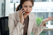 © MIND AND I - Frustrated Asian Female Real Estate Agent Arguing on Phone