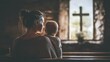 © Sawitree88 - A mother holding her baby while sitting inside a church.