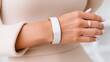 © MarinkaLev - menopause tech, hot flash relief, femtech, wearable cooling concept, close up of a woman wrist wearing a sleek white ceramic cooling bracelet, modern lifestyle