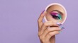 © Ludmila - Woman applying colorful makeup while looking in mirror