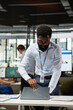 © DC Studio - Confident businessman opening laptop at desk, ready to review budget data and prepare reports ahead of important corporate meeting. African american male employee starting busy day in office.