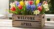 © Naga - Welcome April wooden crate with spring flowers in natural light