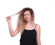 © New Africa - Unhappy woman with tangled hair on white background