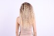 © New Africa - Woman with tangled damaged hair on light grey background, back view