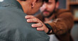 © peopleimages.com - Support, therapist and hand on shoulder, men and compassion for loss, empathy and grief. Sad, help and counseling in office, talking and comfort for emotions, kindness and healing with mental health