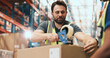 © peopleimages.com - Man, team and tape at warehouse for boxes with logistics, quality assurance and inventory management. Person, cardboard package and tools for safety, shipping and supply chain job at storage plant