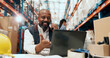 © peopleimages.com - Man, phone call and laptop at warehouse for logistics with talk, schedule or review for inventory management. Person, happy and smartphone with checklist, computer and supply chain at storage plant