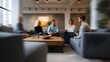 © Thares2020 - Four professionals in a modern lounge sitting on sofas around a coffee table engaged in a focused discussion captured with a dynamic perspective