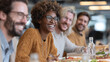 © CinimaticWorks - diverse colleagues laughing and sharing stories during lunch break in modern office cafeteria creating warm business atmosphere of teamwork friendship and employee wellbeing
